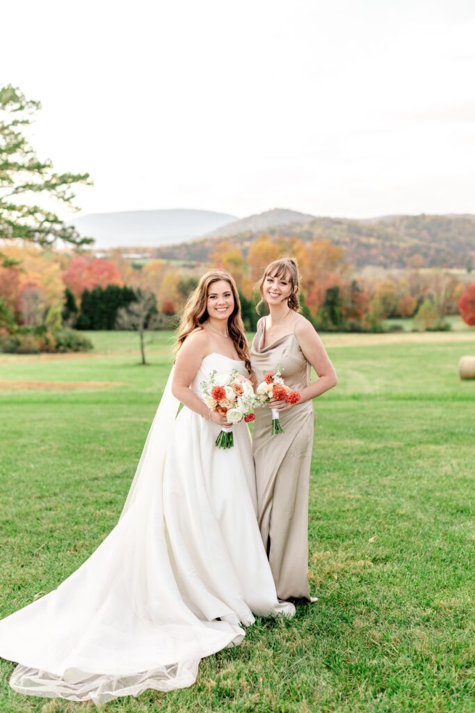 A bride and bridesmaid posing for a classic portrait during a wedding at The Barn at Edgewood