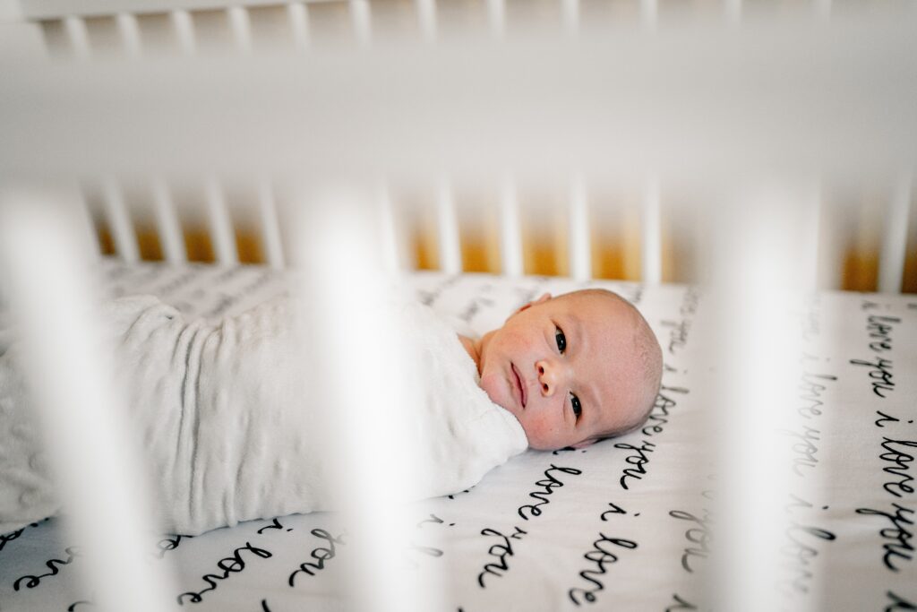 A newborn baby in a crib