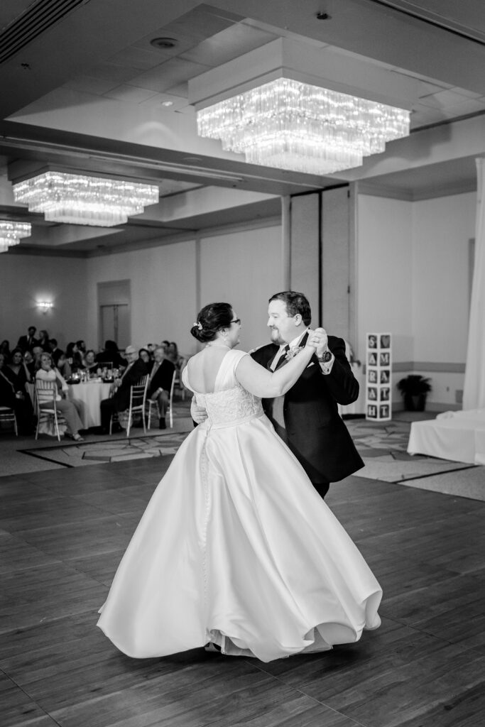 A bride and groom's first dance in a hotel ballroom