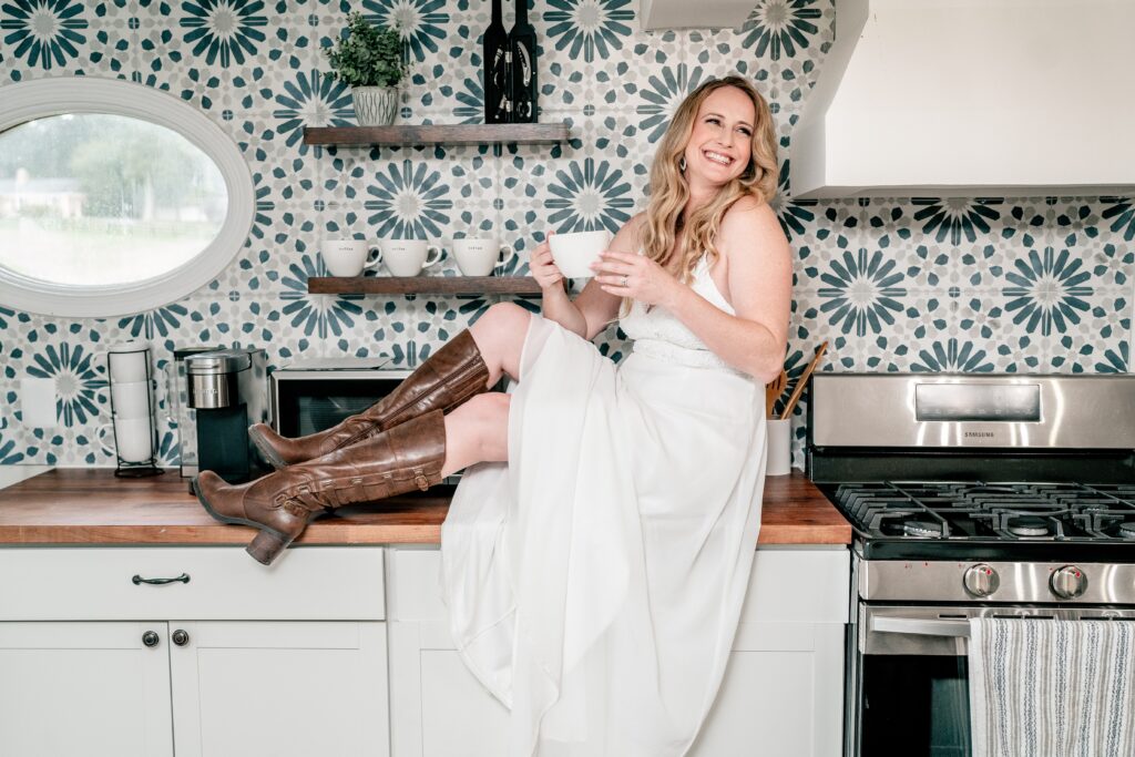 A bride enjoying a cup of coffee in the kitchen of her getting ready suite