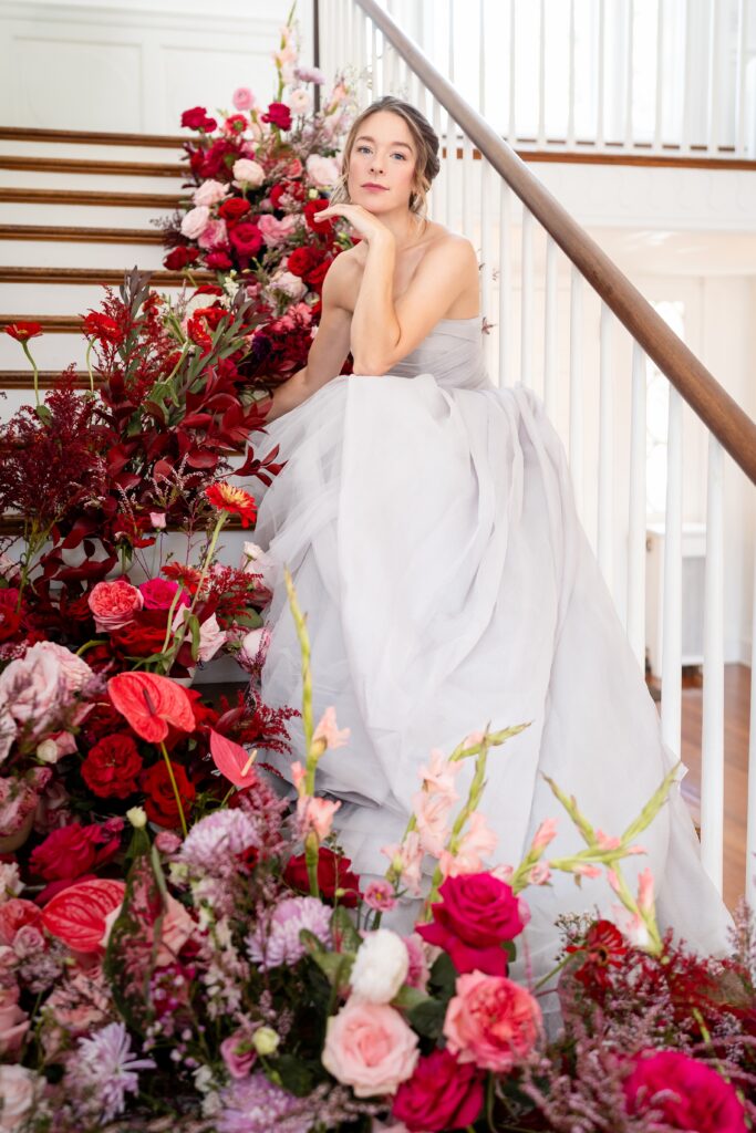 A bride sitting on the staircase for a wedding at Rust Manor House in Leesburg Virginia