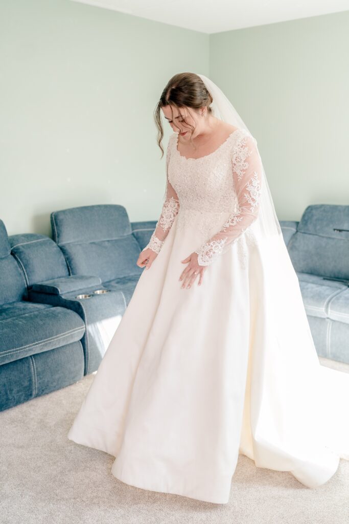 A bride twirls her skirt as she prepares for her wedding