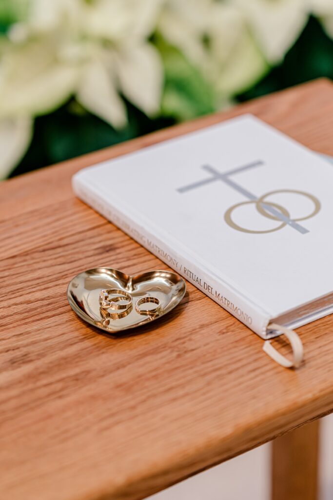 A heart shaped ring dish holding wedding rings before a wedding ceremony