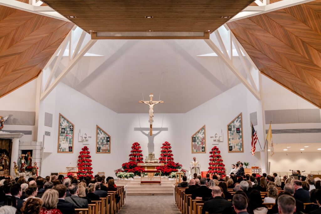 A wide shot of the ceremony space during a Christmas themed wedding at St. Joseph Catholic Church in Herndon Virginia