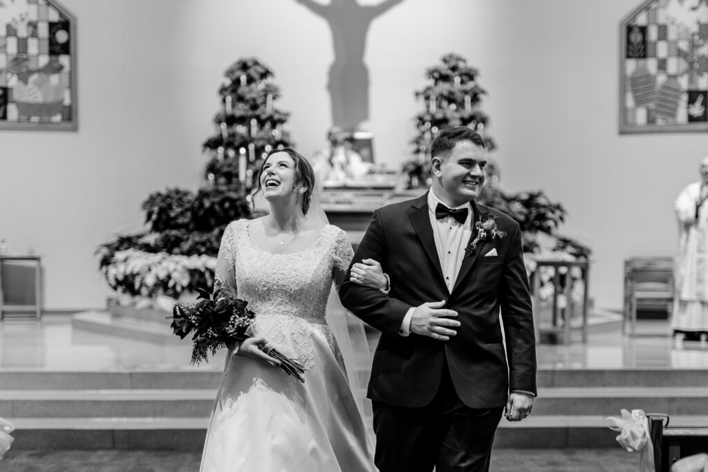 A bride and groom smile as they end the wedding ceremony