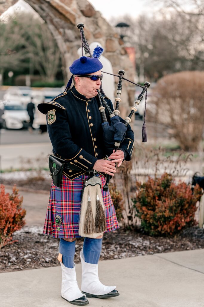 A bagpiper performing at a wedding