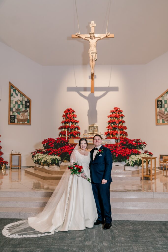 A bride and groom posed for a classic portrait during a Christmas themed wedding at St. Joseph Catholic Church in Herndon Virginia