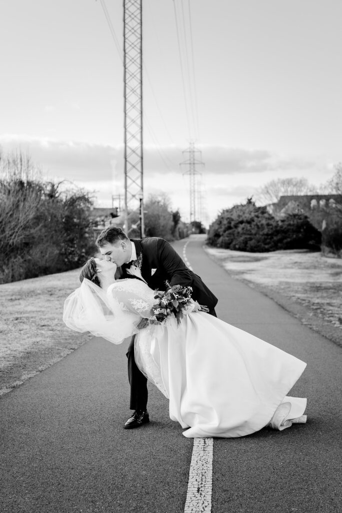 A bride and groom share a dramatic dip kiss during their wedding in Herndon VA