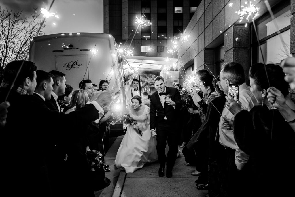 A bride and groom running through a sparkler exit during a Christmas themed wedding in Herndon Virginia