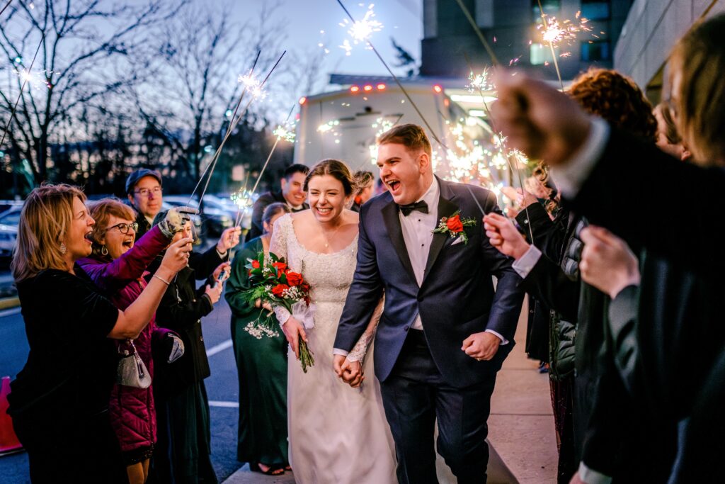 A bride and groom laugh at their sparkler exit during a Christmas themed wedding in Herndon Virginia