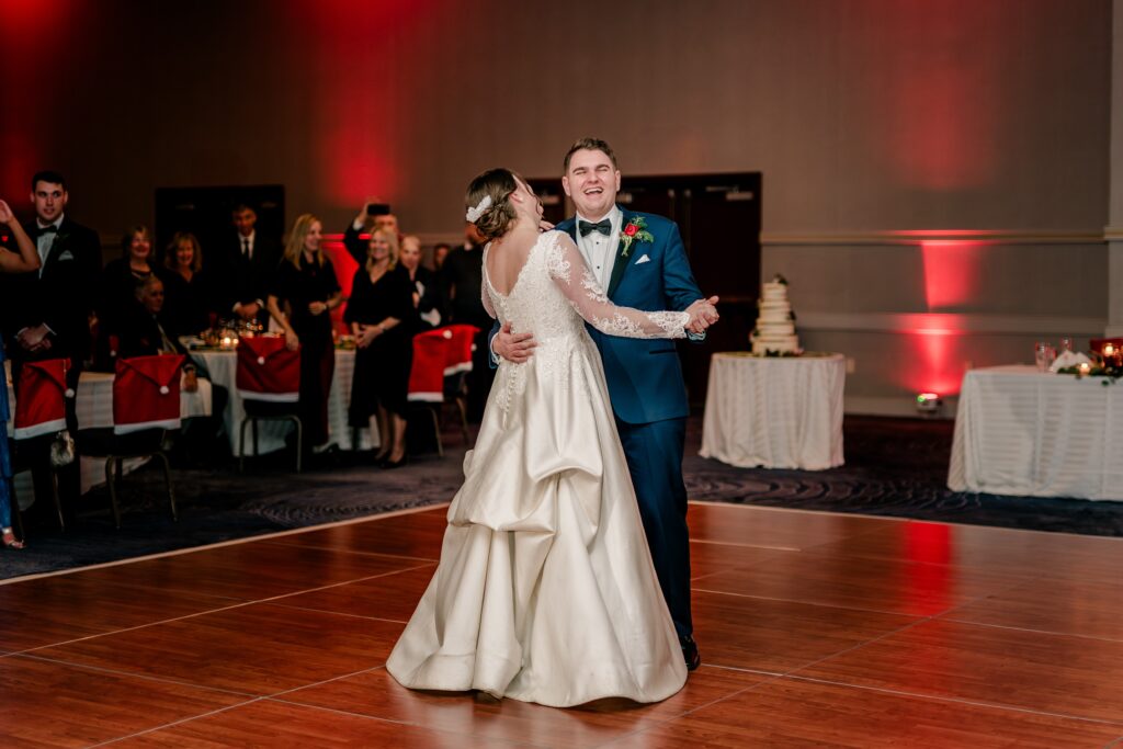 A bride and groom laugh as they dance together during their wedding reception at the Hyatt Regency Dulles in Herndon Virginia