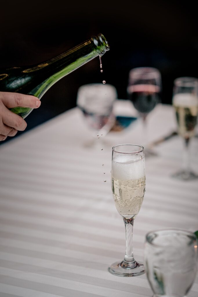 Champagne drips from the bottle as it's being poured for a wedding in Herndon VA