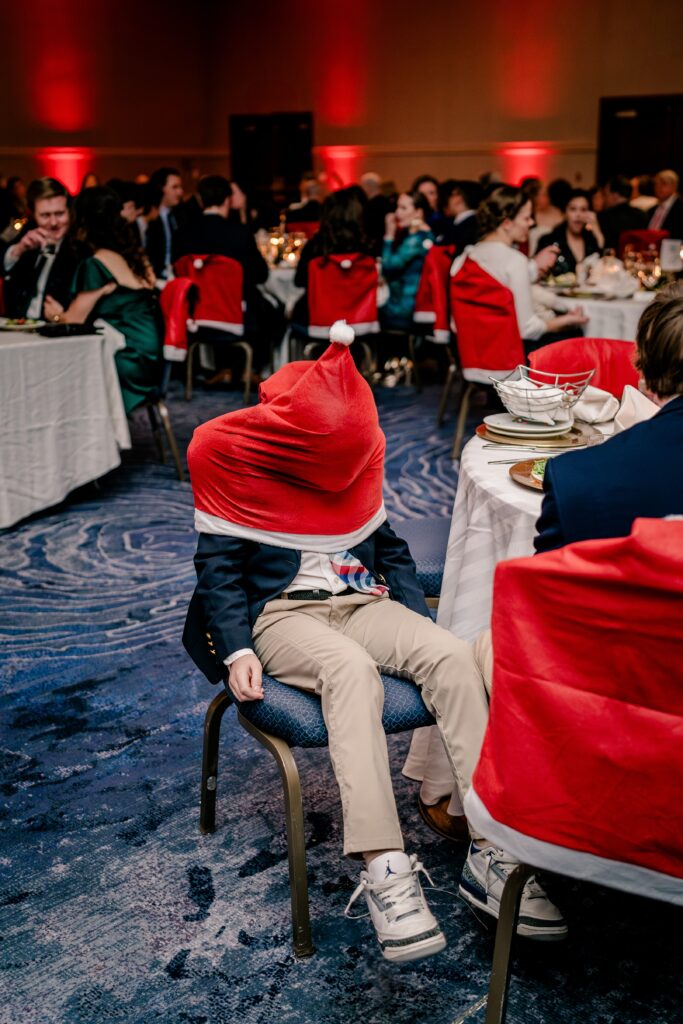 A young boy has fun with the decorations during a Christmas themed wedding at the Hyatt Regency Dulles in Herndon Virginia