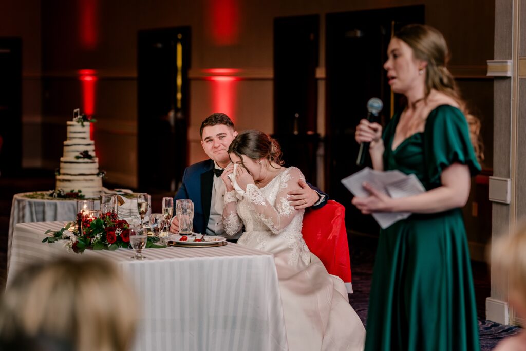 A bride and groom get emotional during a toast at their Christmas themed wedding at the Hyatt Regency Dulles in Herndon Virginia