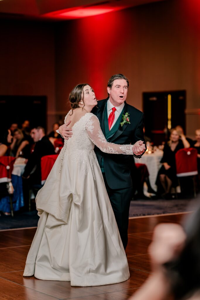 A bride and her father sing together during a Christmas themed wedding at the Hyatt Regency Dulles in Herndon Virginia