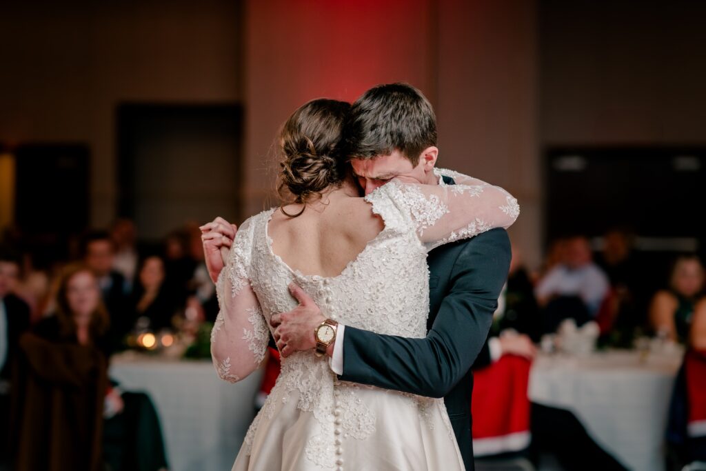 The bride's brother emotionally dances with his sister during her wedding