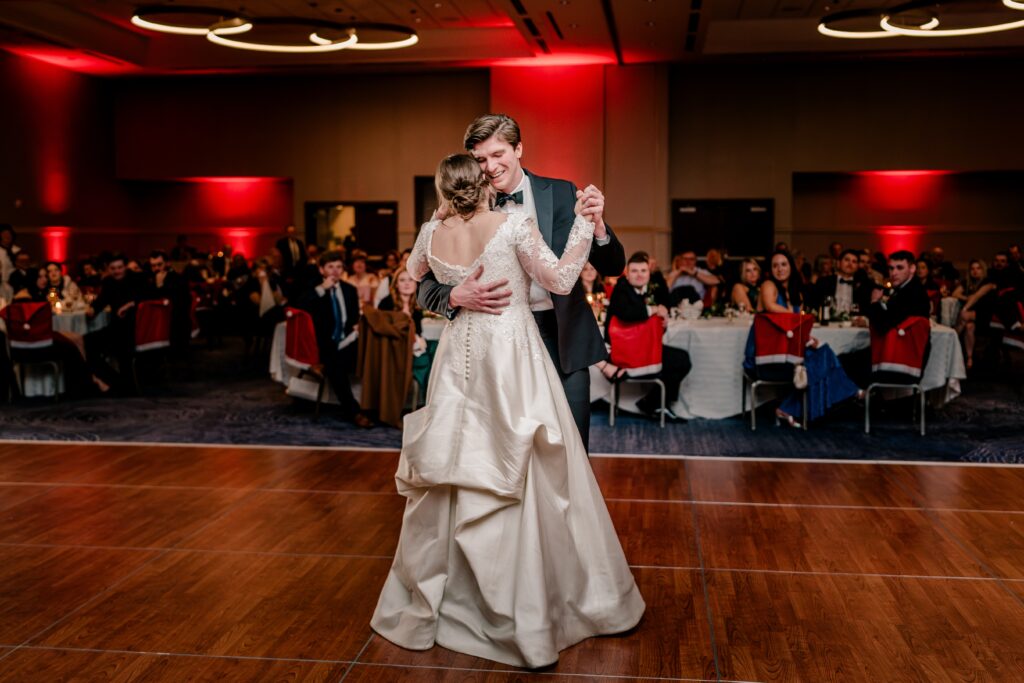 A bride dancing with her brother during a Christmas themed wedding at the Hyatt Regency Dulles in Herndon Virginia