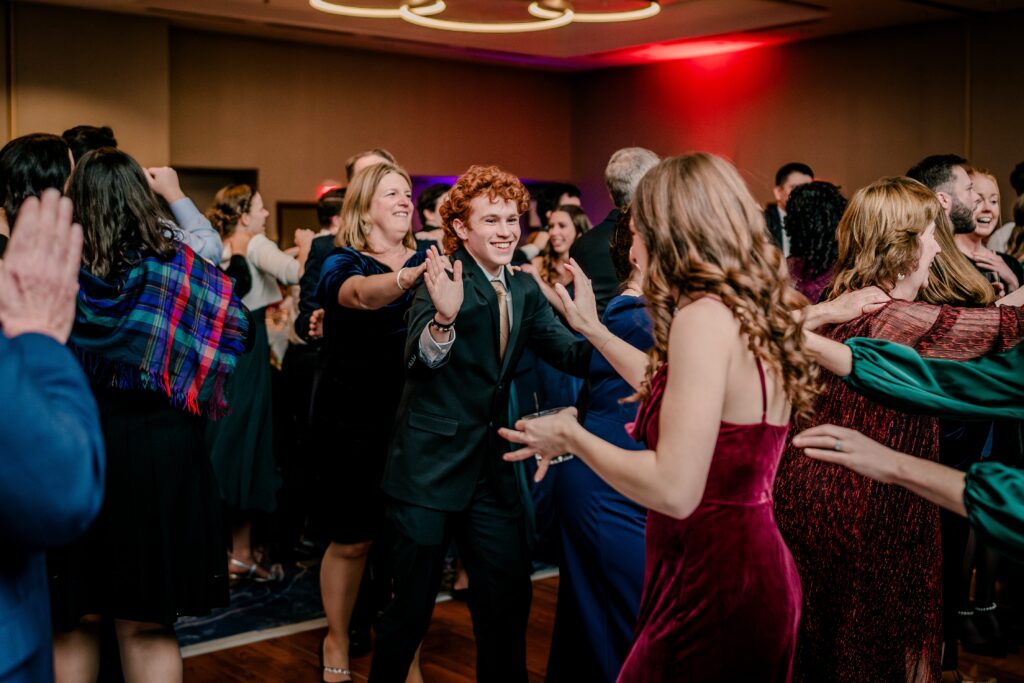 Wedding guests high five during a reception at the Hyatt Regency Dulles in Herndon VA