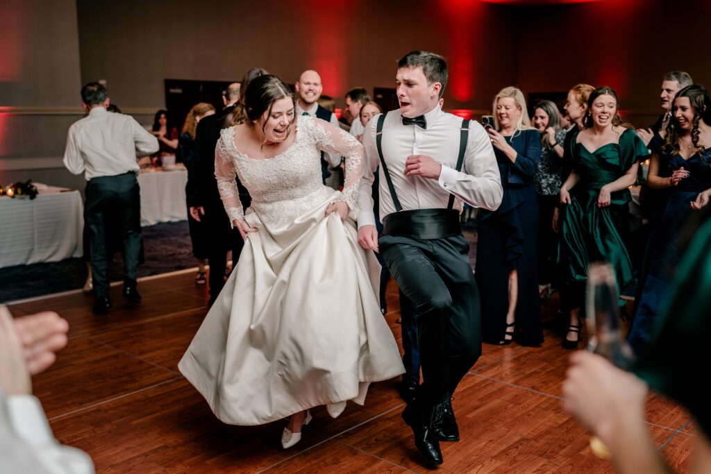 A bride dancing with her brother during a Christmas themed wedding at the Hyatt Regency Dulles in Herndon Virginia