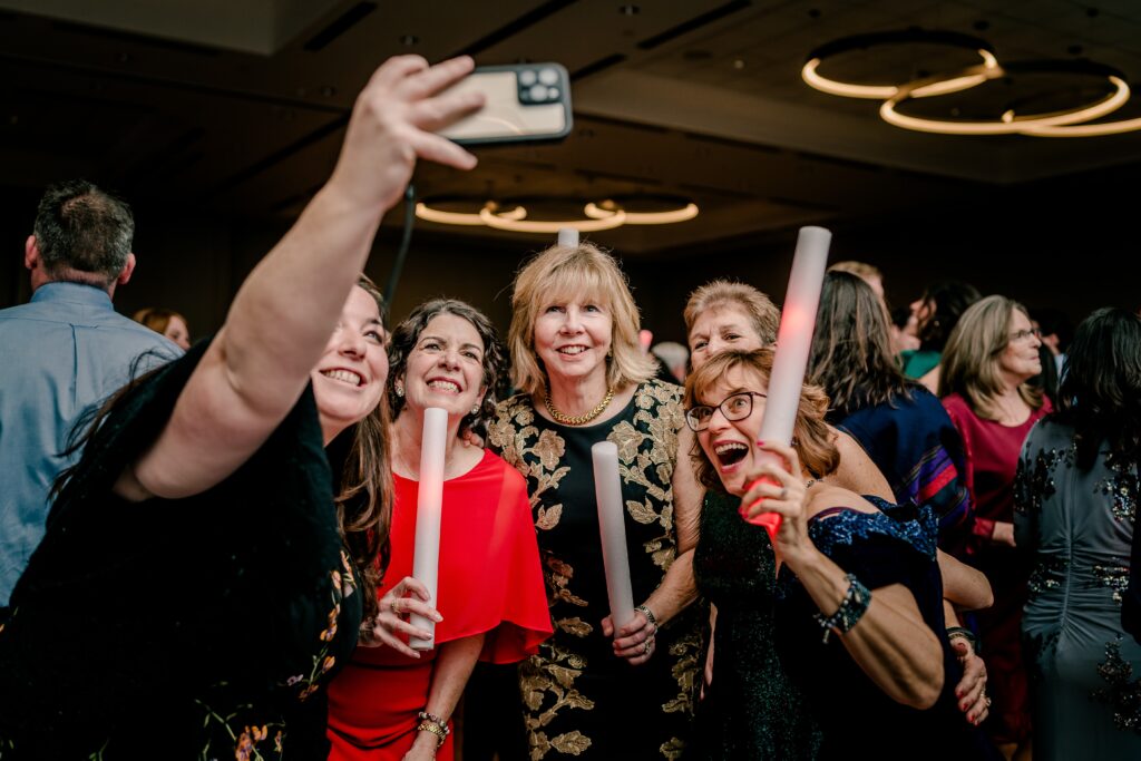 Guests taking a selfie on the dance floor during a hotel wedding near Dulles Airport