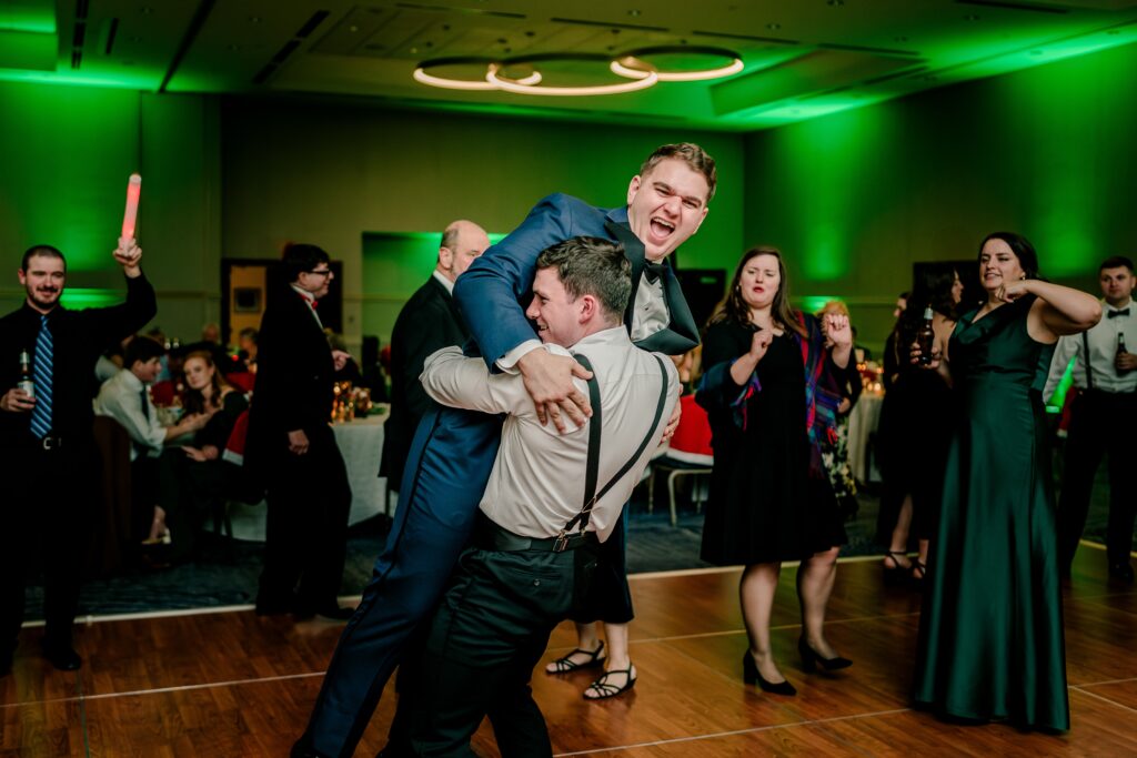 A groom dancing with guests during a ballroom wedding reception in Northern Virginia