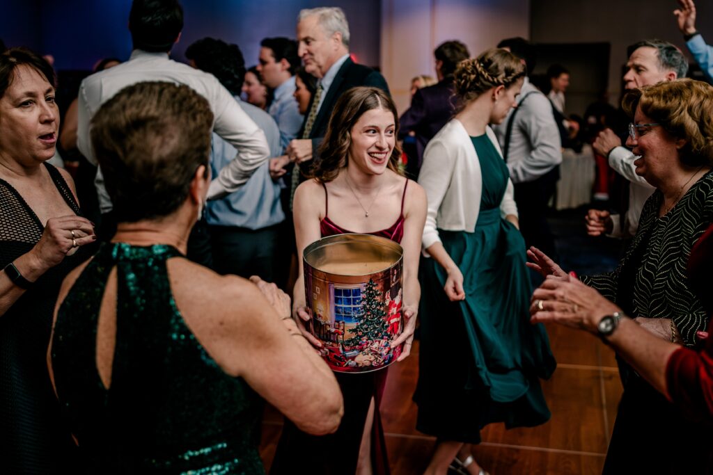 A wedding guest passes out cookies on the dance floor during a Christmas themed wedding at the Hyatt Regency Dulles in Herndon Virginia