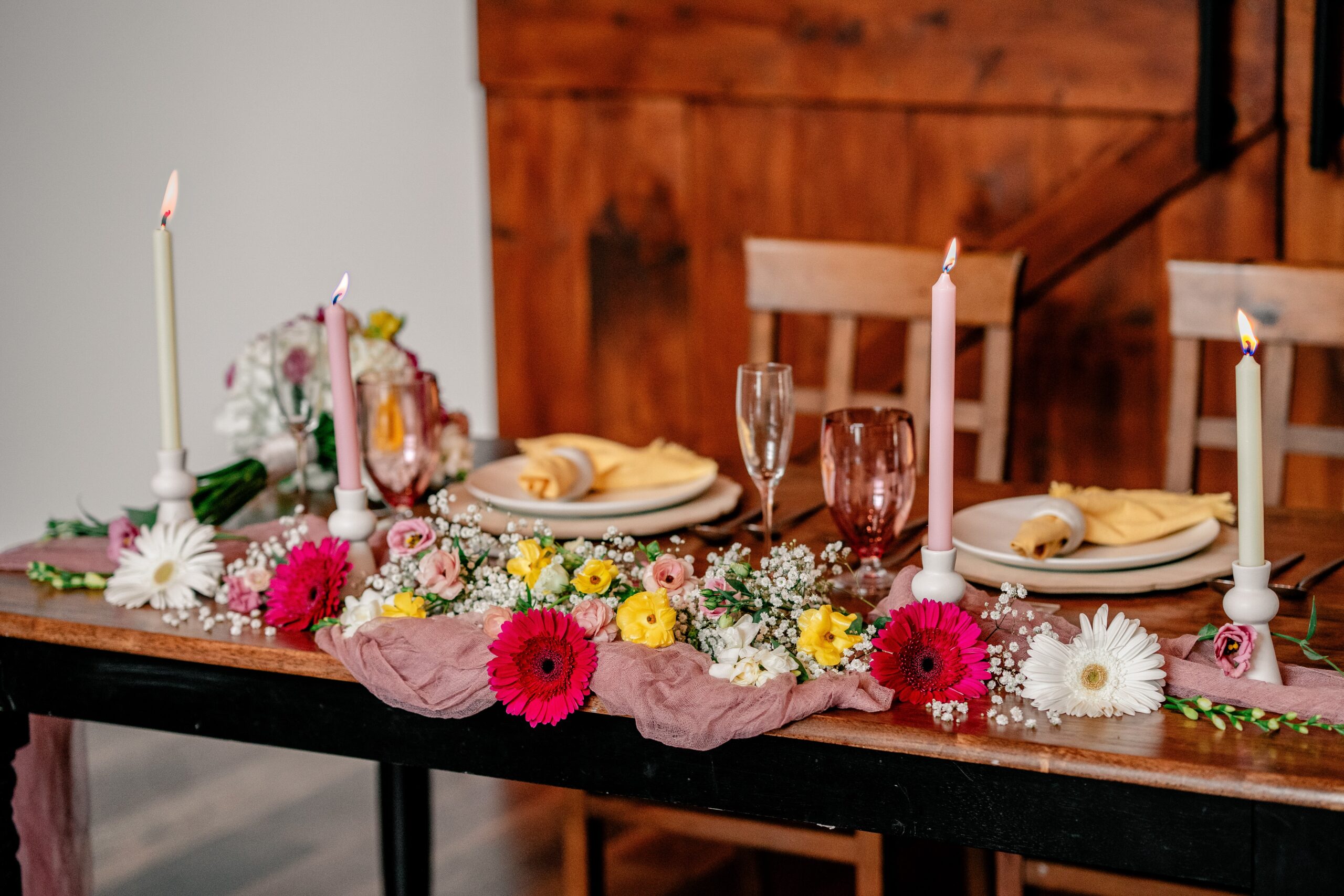 Colorful flowers decorating a sweetheart table at Halcyon Watson, a modern barn wedding venue in Leesburg Virginia