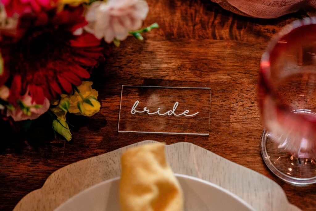 Handwritten acrylic place cards for a wedding reception