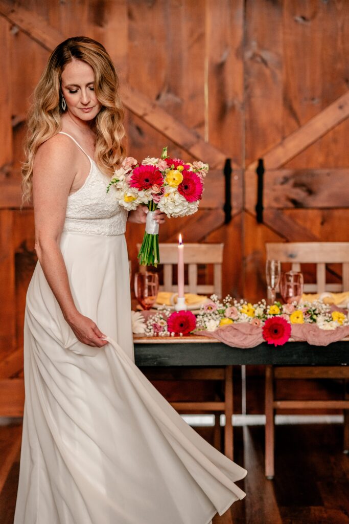 A bride twirling her skirt for a bridal portrait at her wedding reception venue in Northern Virginia Halcyon Watson