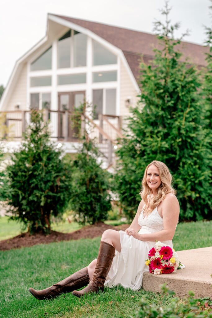 A bride sitting on a step outside her wedding reception in Loudoun County