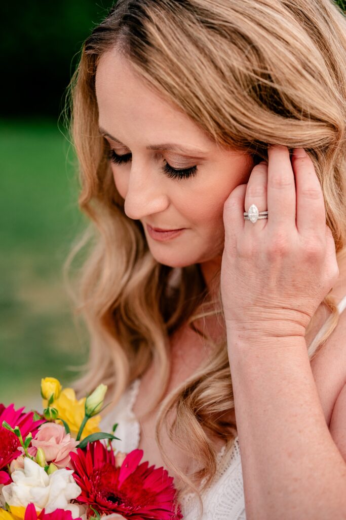 A bride showing off her engagement ring and makeup by Sandra Makeup Artistry