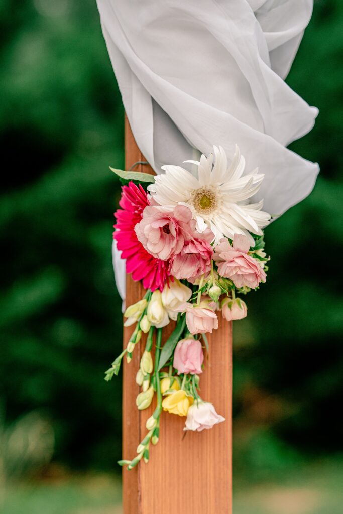 A close up of the ceremony arch with flowers by Mystical Rose Flowers