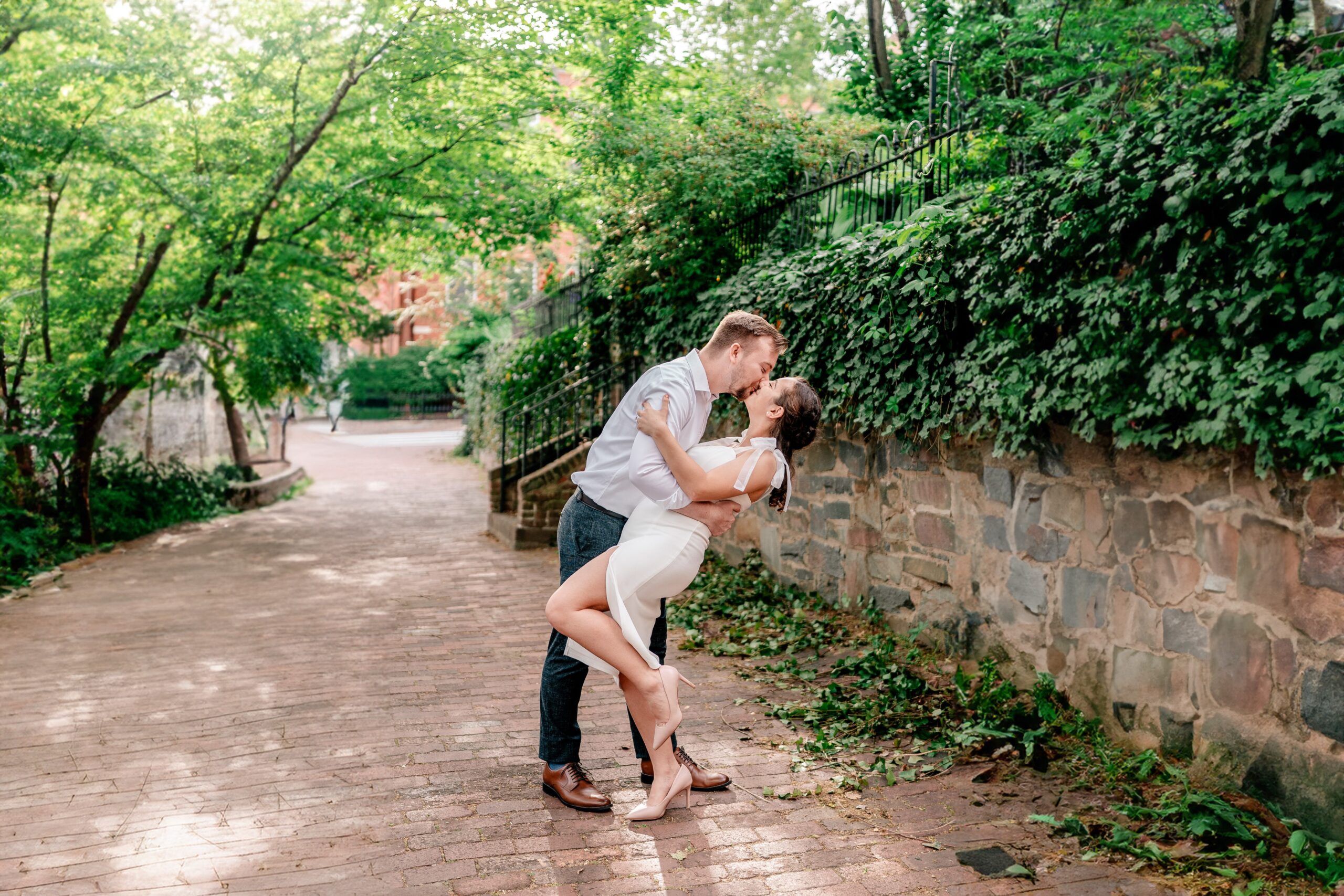 Georgetown DC engagement photos for a couple sharing a sweet kiss on the sidewalk