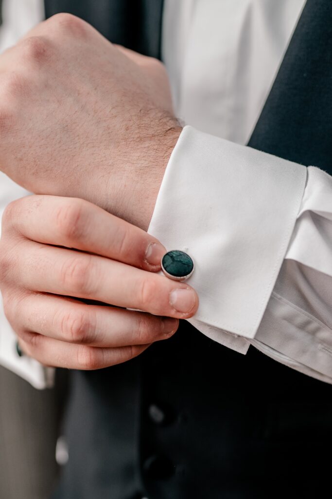 A groom adjusts his cufflinks with Northern Virginia wedding photographer Beauty of the Soul Studio