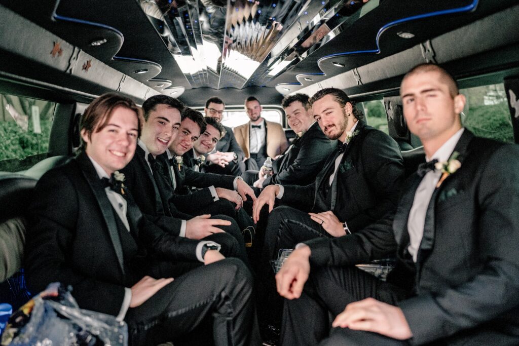 The groom and groomsmen in the limo before the ceremony