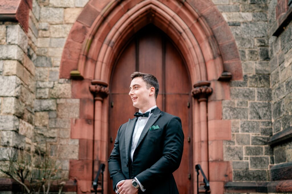 A groom posing for a portrait before his St Dominic DC wedding