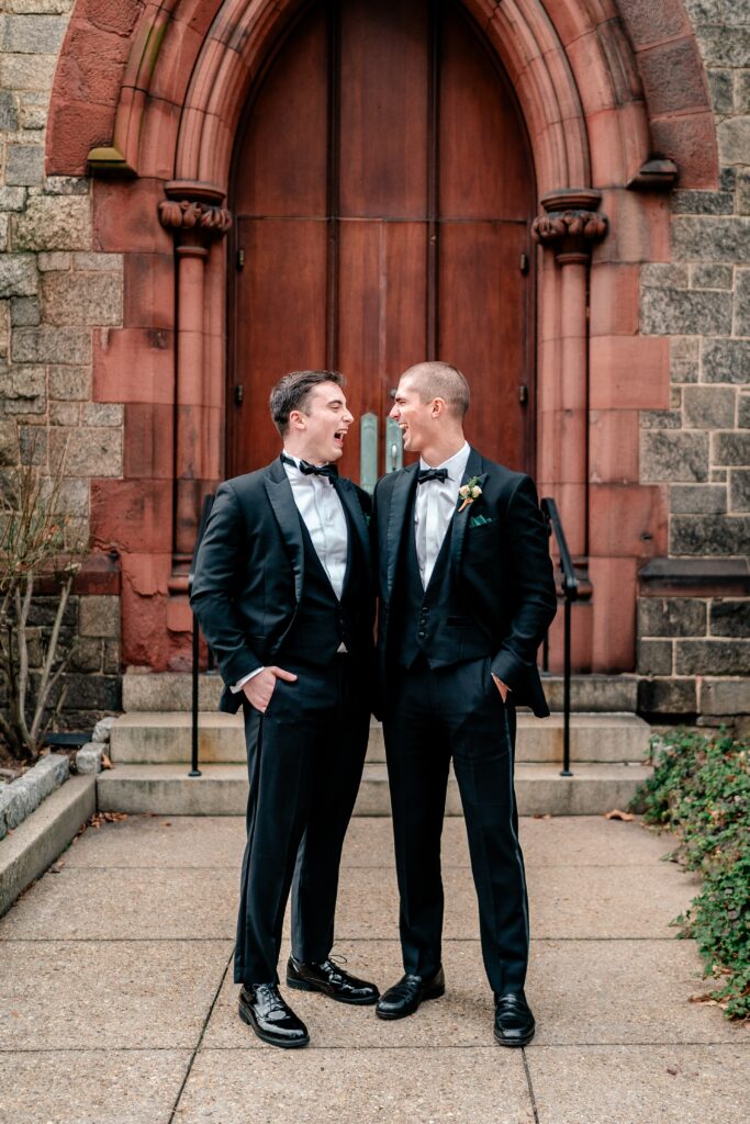 A groom and his best man laughing together before his DC Christmas wedding