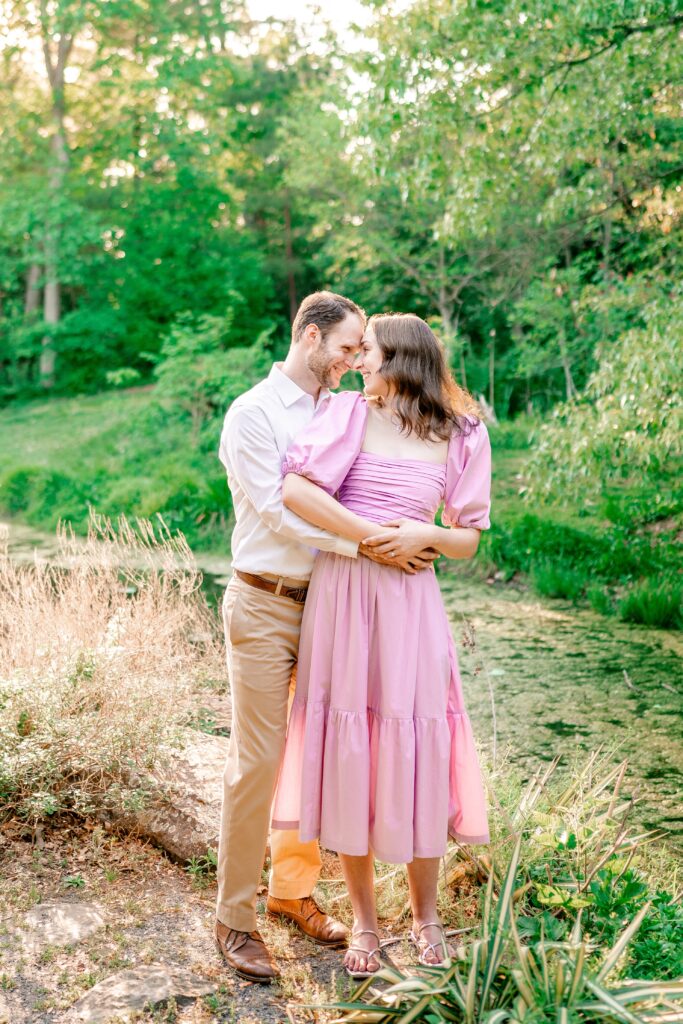 An engaged couple nuzzles closely during their Green Spring Gardens photos
