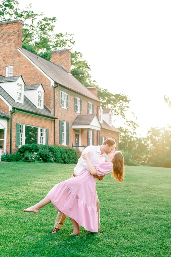 An engaged couple shares a dramatic dip kiss for their Northern Virginia engagement photographer
