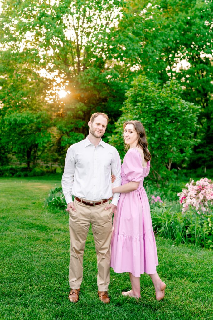 A classic portrait of an engaged couple with her looking over her shoulder at the camera