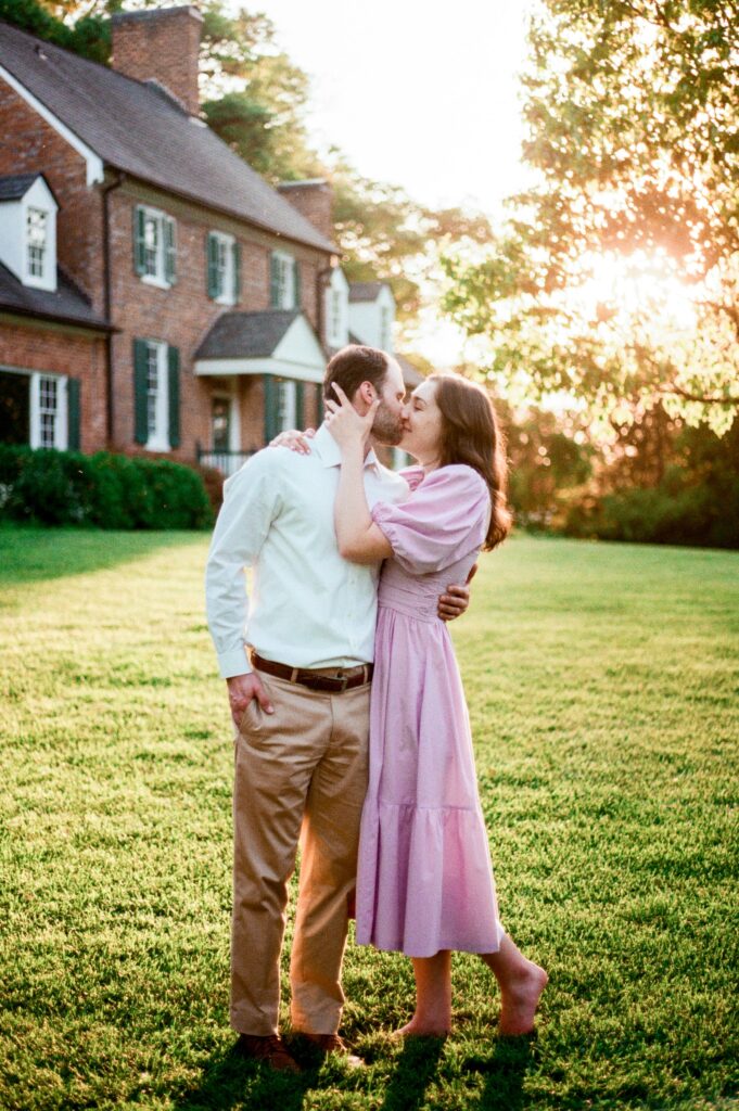 A couple shares a happy kiss on film at at one of the best garden venues in Northern Virginia