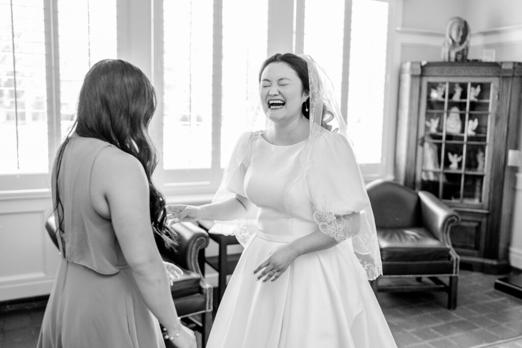 A bride laughing while getting ready for her wedding