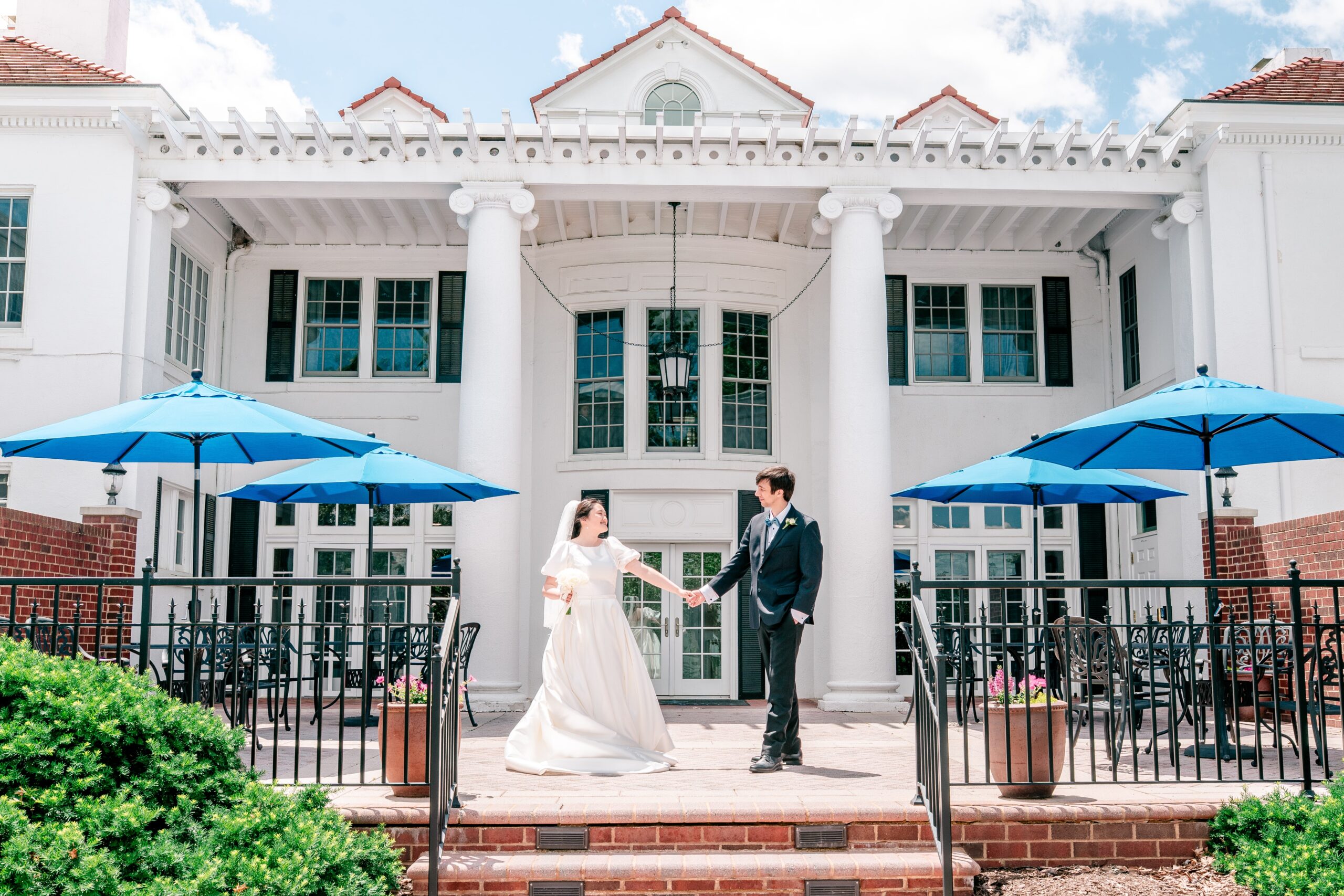 A bride and groom twirling together on a patio before their Union Street Public House wedding