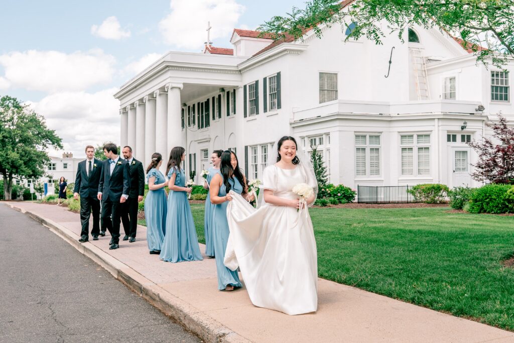 A wedding party walking along the sidewalk together