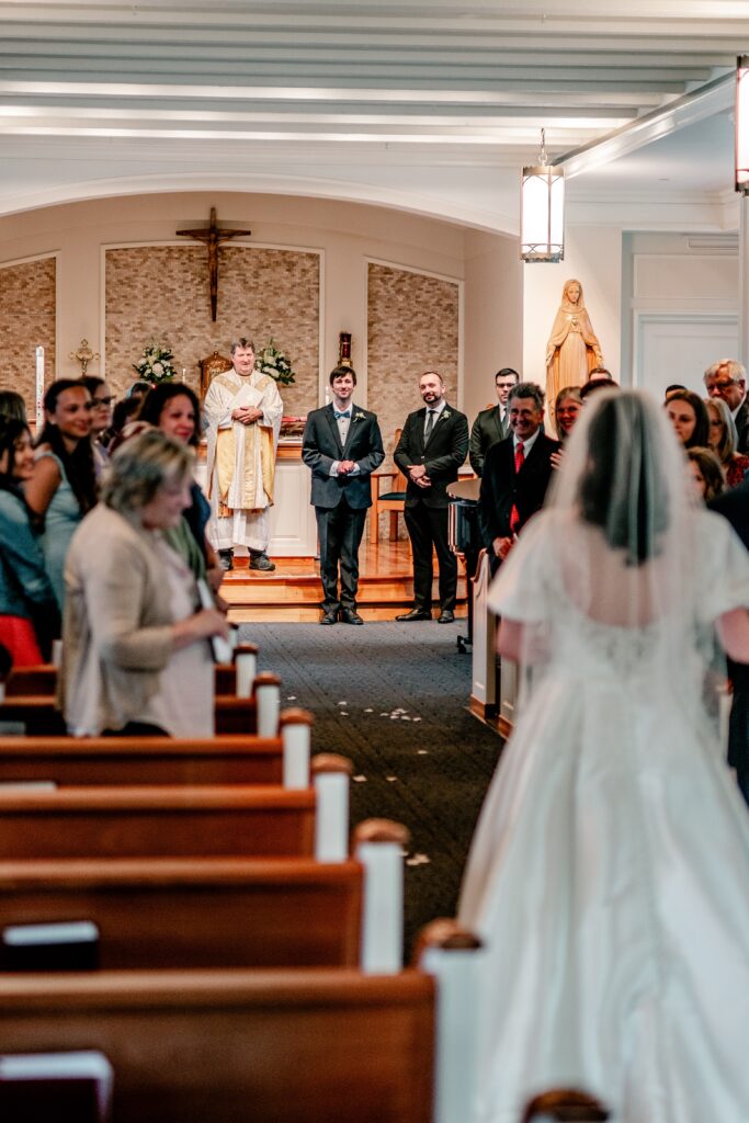 A groom waiting for his bride to walk down the aisle