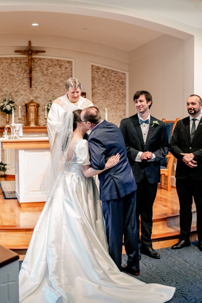 A bride's father kissing her goodbye during her wedding ceremony by Northern Virginia wedding photographer