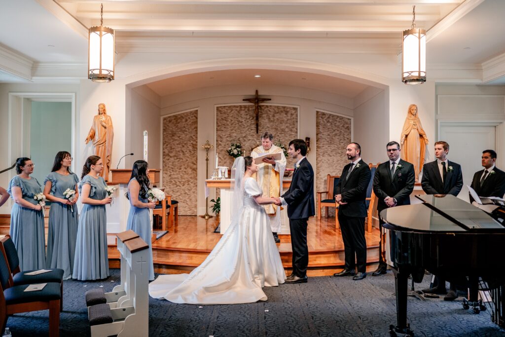 The bridal party waiting at the front of a chapel