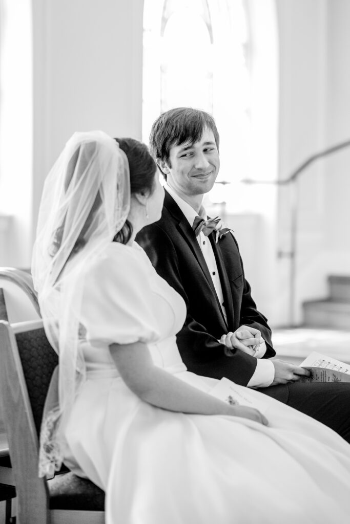 A groom smiling at his bride during their ceremony the day of their Union Street Public House wedding