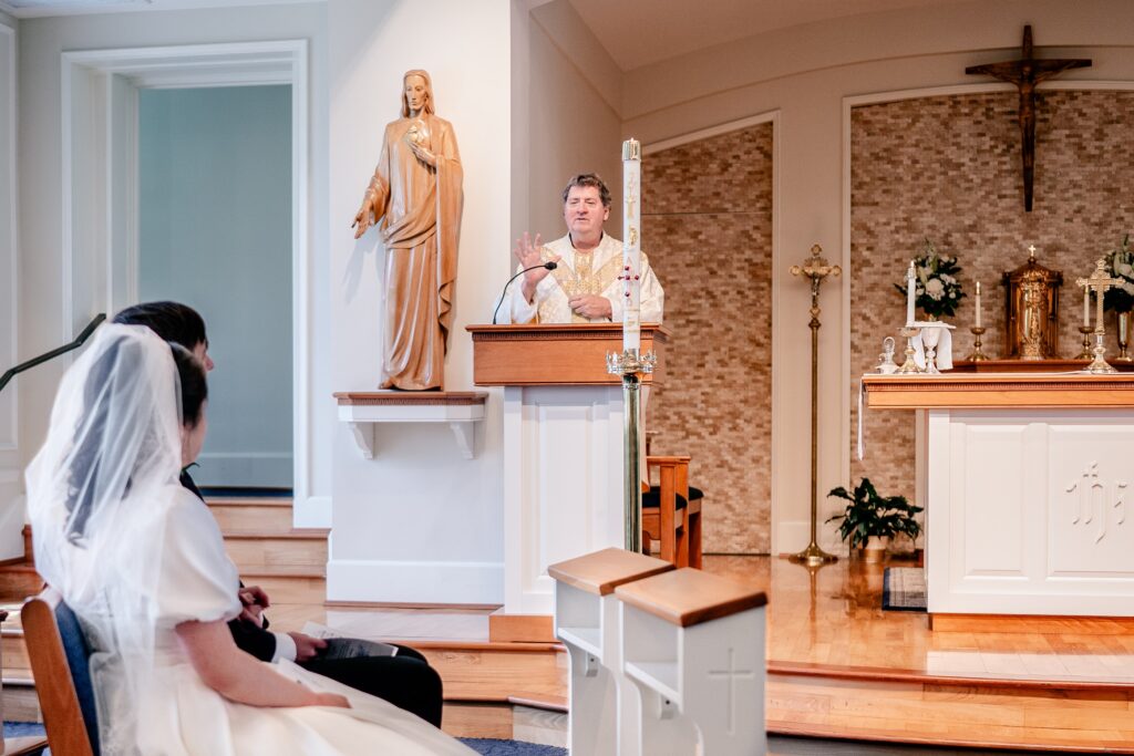 A priest giving a homily during a wedding