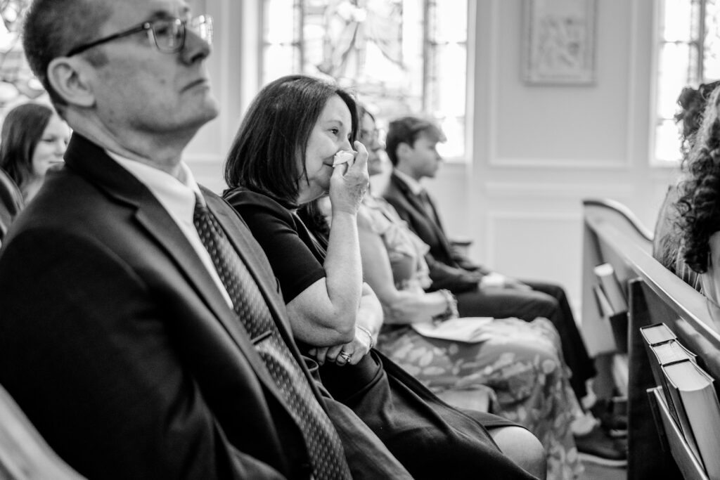 A bride's mother wiping tears away during their Union Street Public House wedding